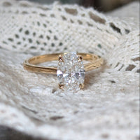 Gold ring with a diamond on a lace fabric