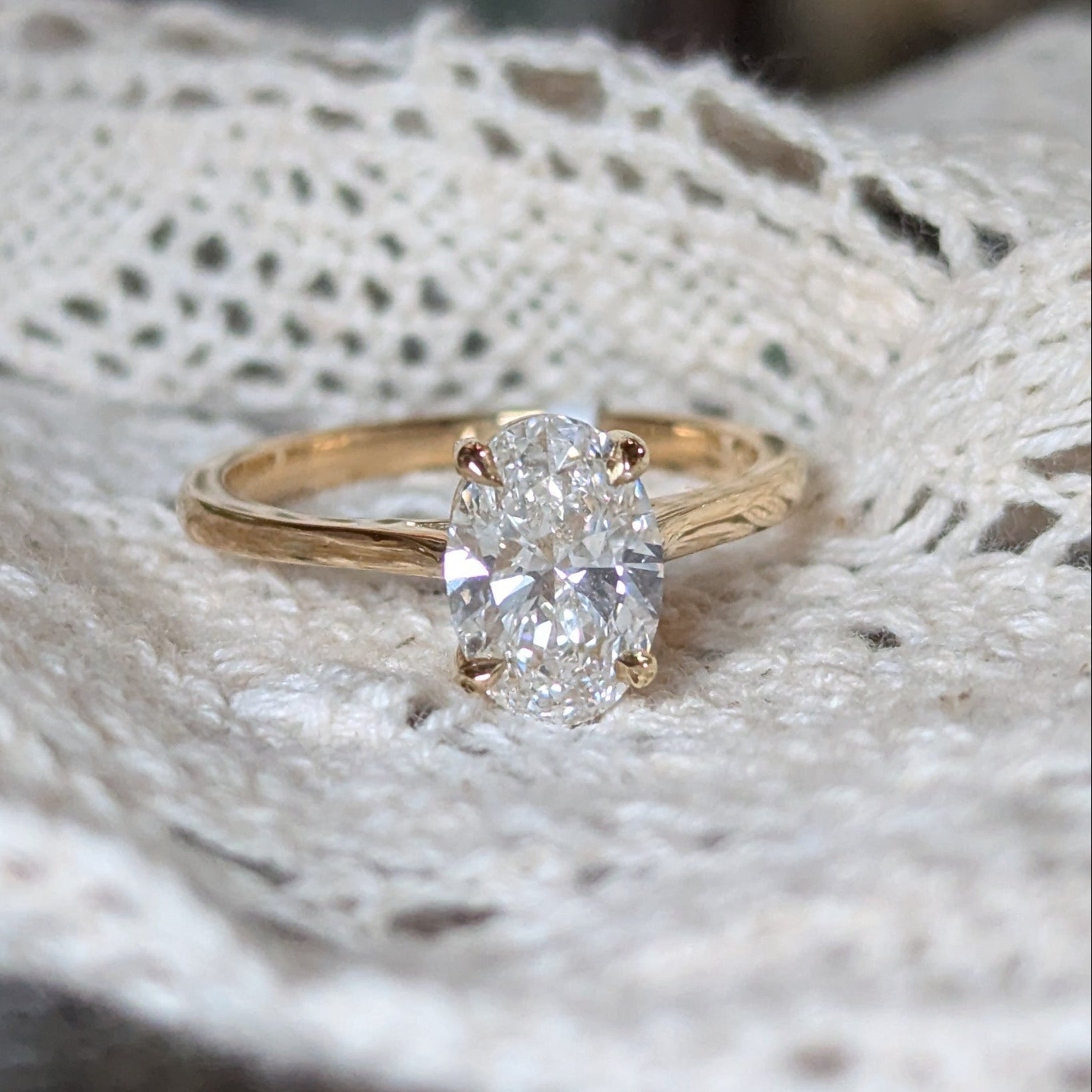 Gold ring with a diamond on a lace fabric
