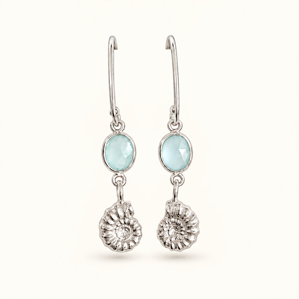 A pair of silver drop earrings featuring oval green agate with sterling silver ammonite fossil. 