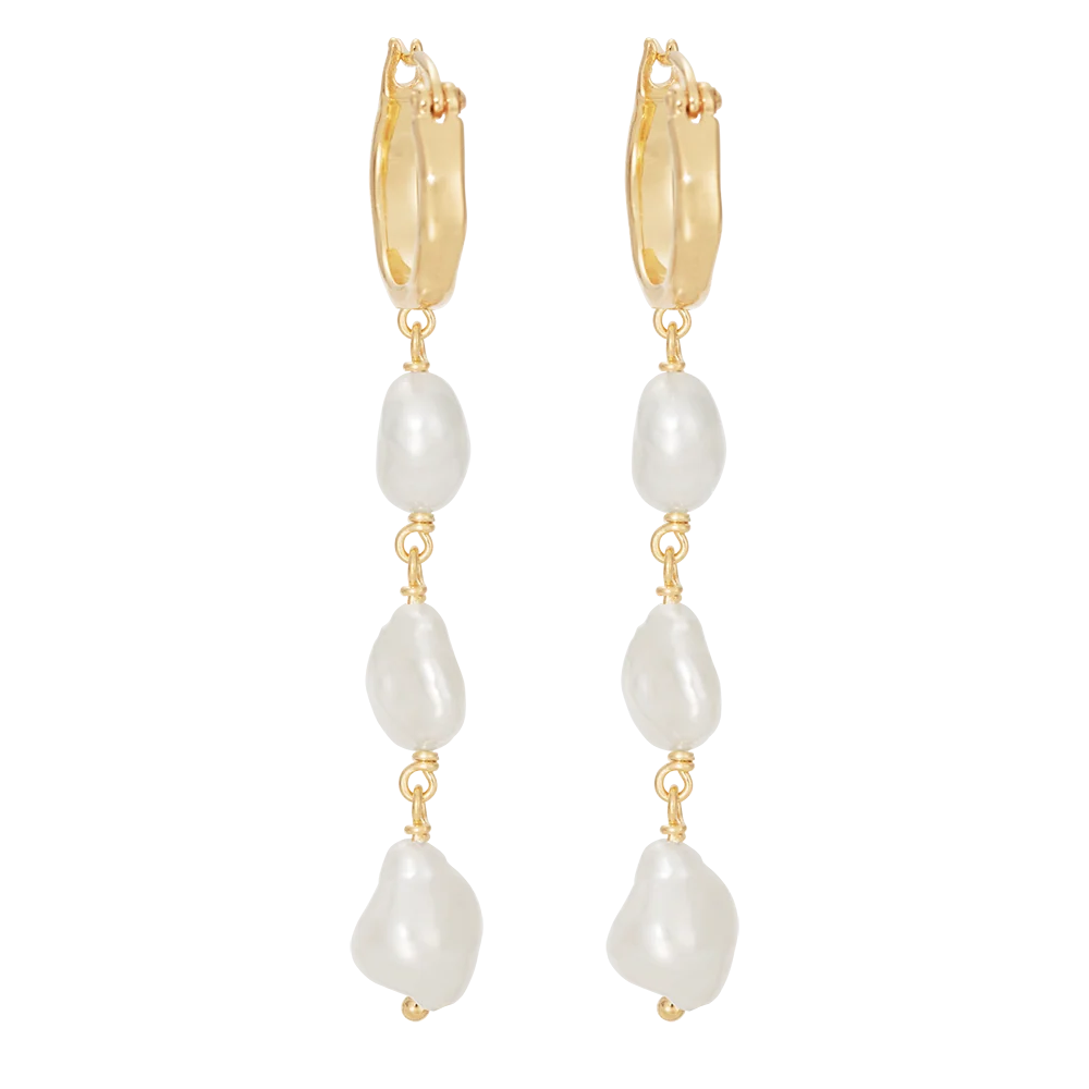 A pair of gold huggie hoop earrings with a dangling freshwater pearl bead drop, shown against a plain white background.