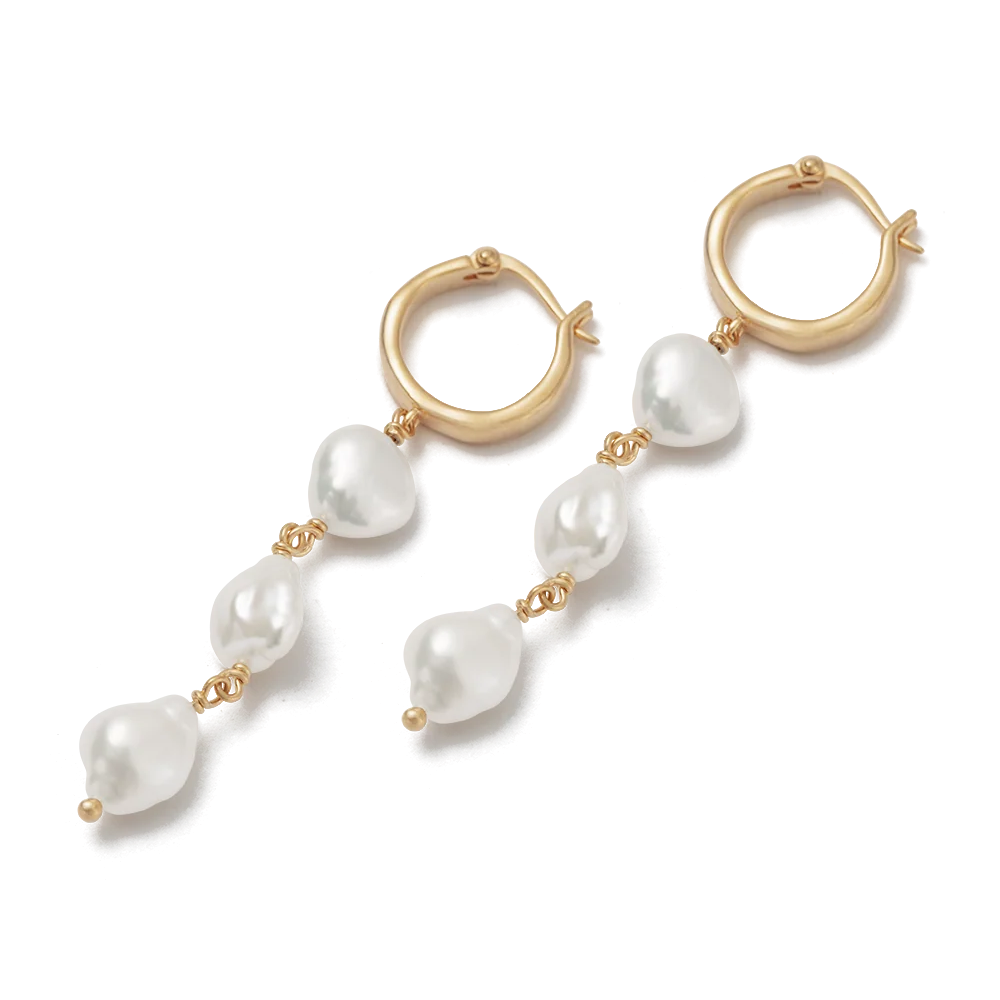 A pair of gold hoop earrings with freshwater baroque pearl beads, shown on a clean white background.